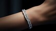© lililia - a young woman's hand gracefully adorned with a diamond bracelet, ensuring that the fine details of the jewelry sparkle against a light-toned backdrop.