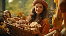 A Woman Walks Through The Autumn Forest With Mushrooms In A Wicker Basket. Picking Mushrooms In The Forest In Autumn. Autumn Season. Close-up.