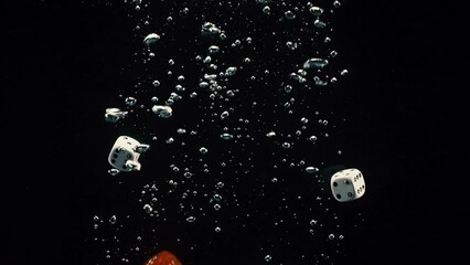 Poster - Group of colorful dice splashing on the water with black background