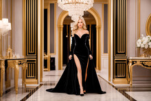 Beautiful Blonde Woman In A Luxurious Long Evening Black Dress In The Palace.Princess Clothes.Creative Designer Fashion Glamour Art.