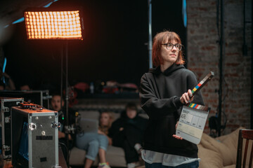 Wall Mural - Assistant director with clapperboard on set. Close-up of firecrackers for filming a movie