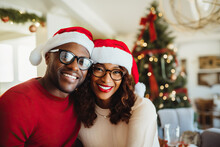 Black Man And A Woman Wearing Christmas Hats Created With Generative AI Technology
