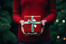 Anonymous Woman In A Red Sweater Holding A Red Gift Box Created With Generative AI Technology