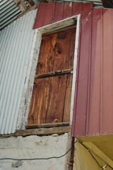 Sticker - Two-story wooden and metal-clad building with a large wooden door