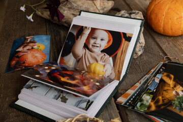 Wall Mural - Open picture album with Halloween printed photos.