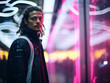 © Boadicea - Cool young man on night city street with neon lights.