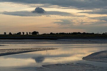 Wall Mural - Scenic view of a tranquil lake at a cloudy sunset