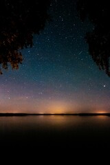 Sticker - Vertical shot of stars shining brightly in the sky in darkness at nighttime