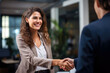 © Danny - Happy Middle-Aged Businesswoman Manager Extends a Warm Handshake to Greet a Valued Client in the Office