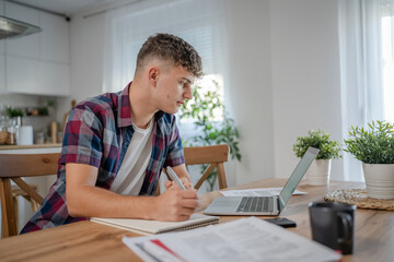 Young caucasian man teenager student study at home