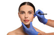 © New Africa - Doctor with pencil preparing patient for cosmetic surgery operation on white background, closeup