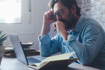 One freelance man in smart working home office workplace using laptop and thinking for solution. Portrait of modern businessman small on line business management. People and computer digital job web