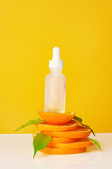 Wall Mural - Skincare oil bottle on stacked orange slices