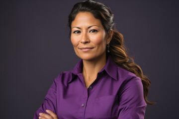 Wall Mural - Woman wearing purple shirt is posing for picture. This image can be used for various purposes, such as social media posts, blog articles, or advertising campaigns.