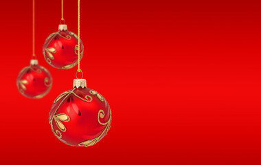 Wall Mural - Hanging Christmas ornaments on red background with copy space