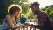 couple holding hands over chess board in park
