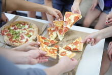 Adults And Children Take Slice Of Pizza On Box. Fast Food Delivery Concep