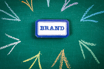 Wall Mural - brand concept. sticker on a green chalkboard background