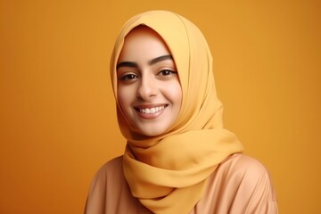 Wall Mural - Smiling happy arab asian muslim woman in yellow hijab clothes isolated on yellow background studio portrait. Uae people middle east islam religious concept. generative AI