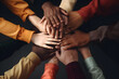 © Rangga Bimantara - Close up top view of young business people putting their hands together. Stack of hands. Unity and teamwork concept. Group of multiracial people