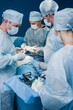 © johnalexandr - Team of surgeons doing operation in hospital