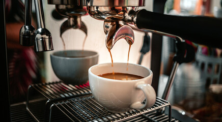 Close-up of espresso pouring from the coffee machine into a coffee cup. Professional coffee brewing