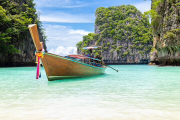 Wall Mural - The Thai traditional wooden longtail boat and beautiful beach in Phuket province, Thailand.