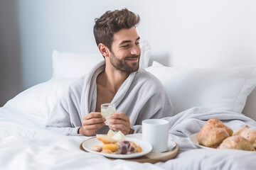 Young gay man eating breakfast in bed