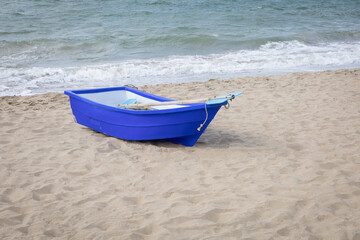 Wall Mural - Blue rowing boat on the beach