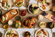 Top view background of cozy dinner table set for Thanksgiving with delicious roasted turkey and comfort food, copy space