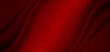 Abstract background, fabric waves or wavy lines, red silk or textiles for background. Elegant red background or dark wallpaper.	