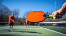 Pickleball Is Racket Or Paddle Sport In Which Two Singles Or Four Doubles Players Hit A Perforated Hollow Plastic Ball. Players On Pickleball Court