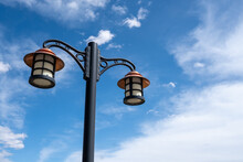 Blue Sky And Worn Vintage Street Lamp