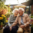 © kora studio - happy senior couple sitting on bench