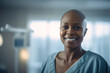 Happy African American Woman undergoing chemotherapy, cancer treatment, remission.  Portrait of bald smiling woman in the hospital. Cured patient, healthy woman. 