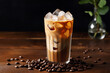 A tall glass of iced coffee topped with milk, condensation on the glass indicating its refreshing nature