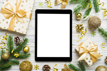 Digital tablet mock up with rustic Christmas decorations for app presentation top view with empty space for you design. Christmas online shopping concept. Tablet with copy space on colored background