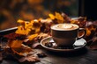 Autumn cozy background, cup of coffee with autumn leaves. Coffee beans, table layout