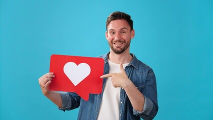 Man shows sign with heart symbol and makes thumbs-up gesture