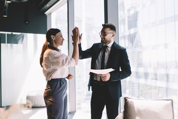 Sticker - Content colleagues giving high five in office