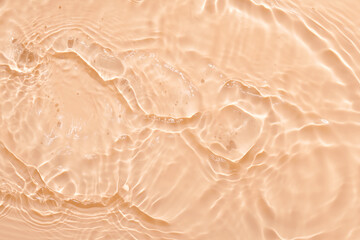 Wall Mural - Water beige surface abstract background. Waves and ripples texture of cosmetic aqua moisturizer with bubbles.