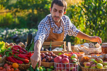 Wall Mural - The farmer sells fruits and vegetables at the farmers market. Selective focus.