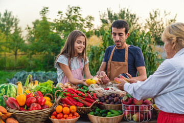 Father and daughter sell vegetables and fruits at the farmers market. Selective focus.