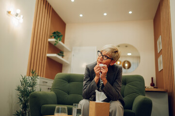 Wall Mural - A depressed woman is sitting in the doctor's office and crying during her session