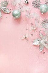 Wall Mural - Christmas background template with copy space top view with silver xmas decor on pink backdrop.Beautiful Xmas greeting card mockup.New Year decor frame 