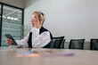 © dikushin - Low-angle view of tired middle-aged businesswoman using mobile phone at office desk, feeling discomfort from dry irritated eyes. Senior adult female suffering from blurry vision eyestrain problem.