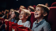 Happy smiling kids sitting in a movie theater and watching a movie.