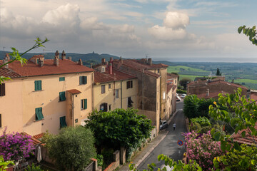 Wall Mural - Rooftop view of the medieval village with the Etruscan coast in the background at sunset in summer, Castagneto Carducci, Livorno, Tuscany, Italy