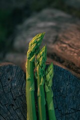 Sticker - Closeup of a fresh, green asparagus on a natural wooden background