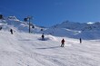 © Elenitsa - Downhill skiers in Hochgurgl ski resort on a beautiful sunny day, perfect conditions for winter sport, skiing and snowboarding in the snow capped alpine mountains in the Ötztal valley, Tyrol, Austria.